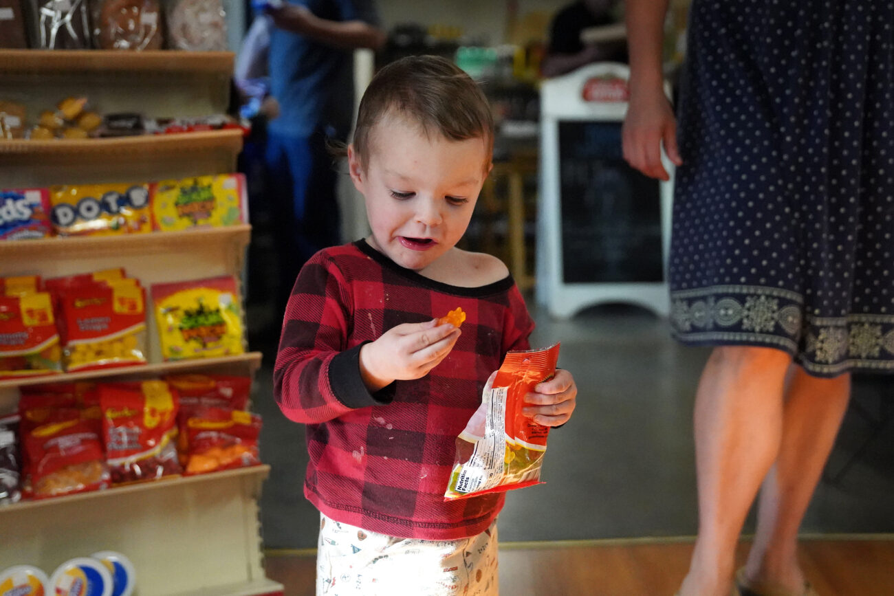 Micheal Joel Fleeman munches on gummy bears at Bald Knob Little Market,in Frankfort, Kentucky on Wednesday, Oct. 5, 2022. Photo by Bryce Towle.