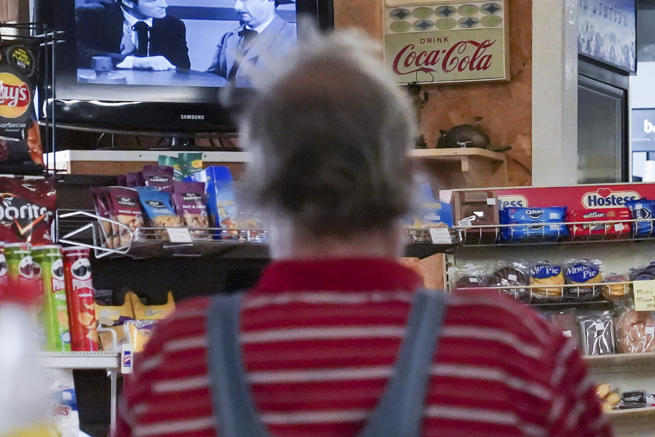 Local patron Rick H. watches the Western that Little Market owner Dan Midkiff put on the television in Frankfort, Kentucky on Wednesday, Oct. 5, 2022. Photo by Bryce Towle.