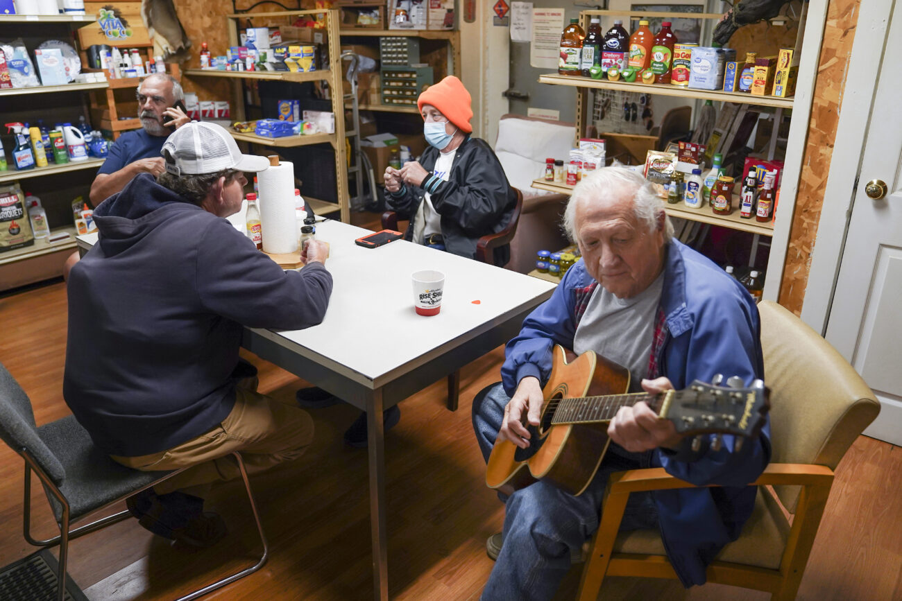 Ed Henson plays guitar for Bald Knob Little Market locals in Frankfort, Kentucky on Thursday, Oct. 6, 2022. Photo by Bryce Towle.