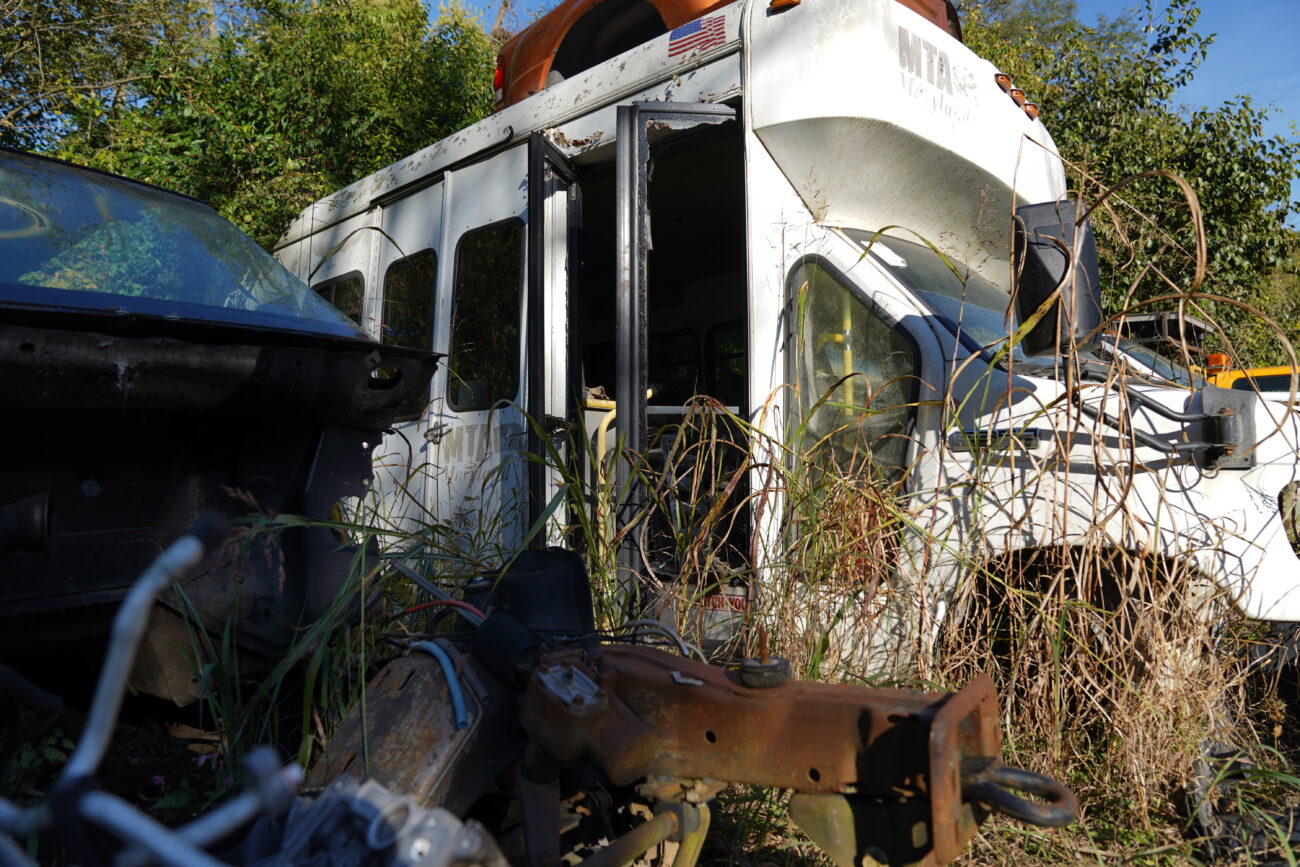 Long stalks of grass grow out of old vehicles in the places that engines once stood on the property of L&M Salvage in Frankfort, Ky. on Wednesday, Oct. 5, 2022. Photo by Carter Skaggs