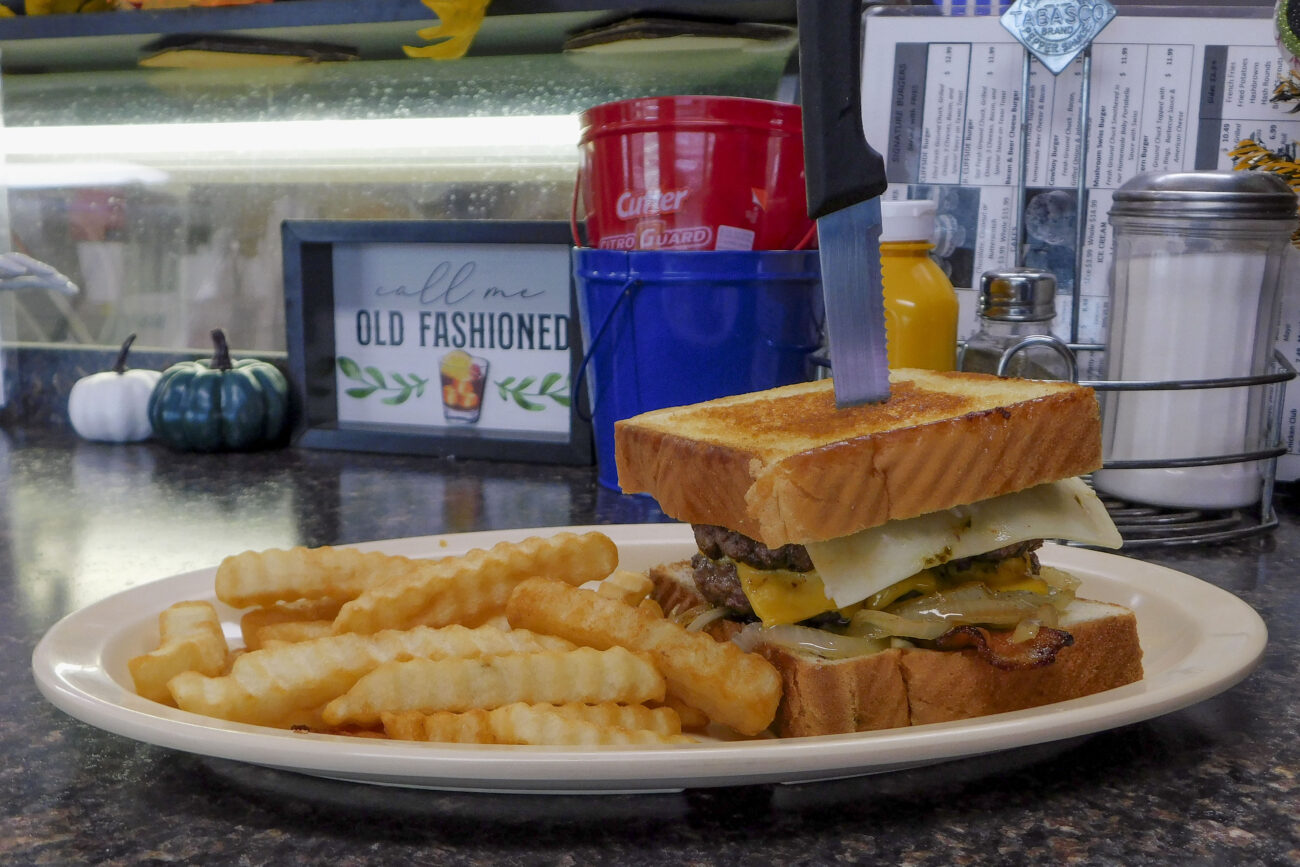 An order of the Cliffside Burger with fries sits on the bar at the Cliffside Diner on Highway 420 in Frankfort, Kentucky. Photo | Austin Collier