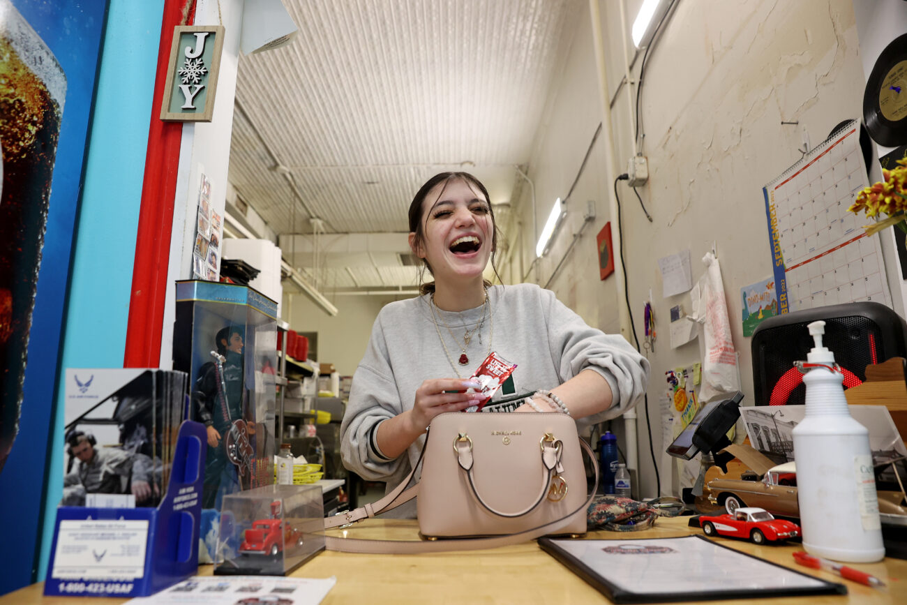 Caitlyn Marrs, a junior at Western Hills High School, laughs while she works at Main Street Diner on Thursday, Oct. 6, 2022, in Frankfort, Kentucky.