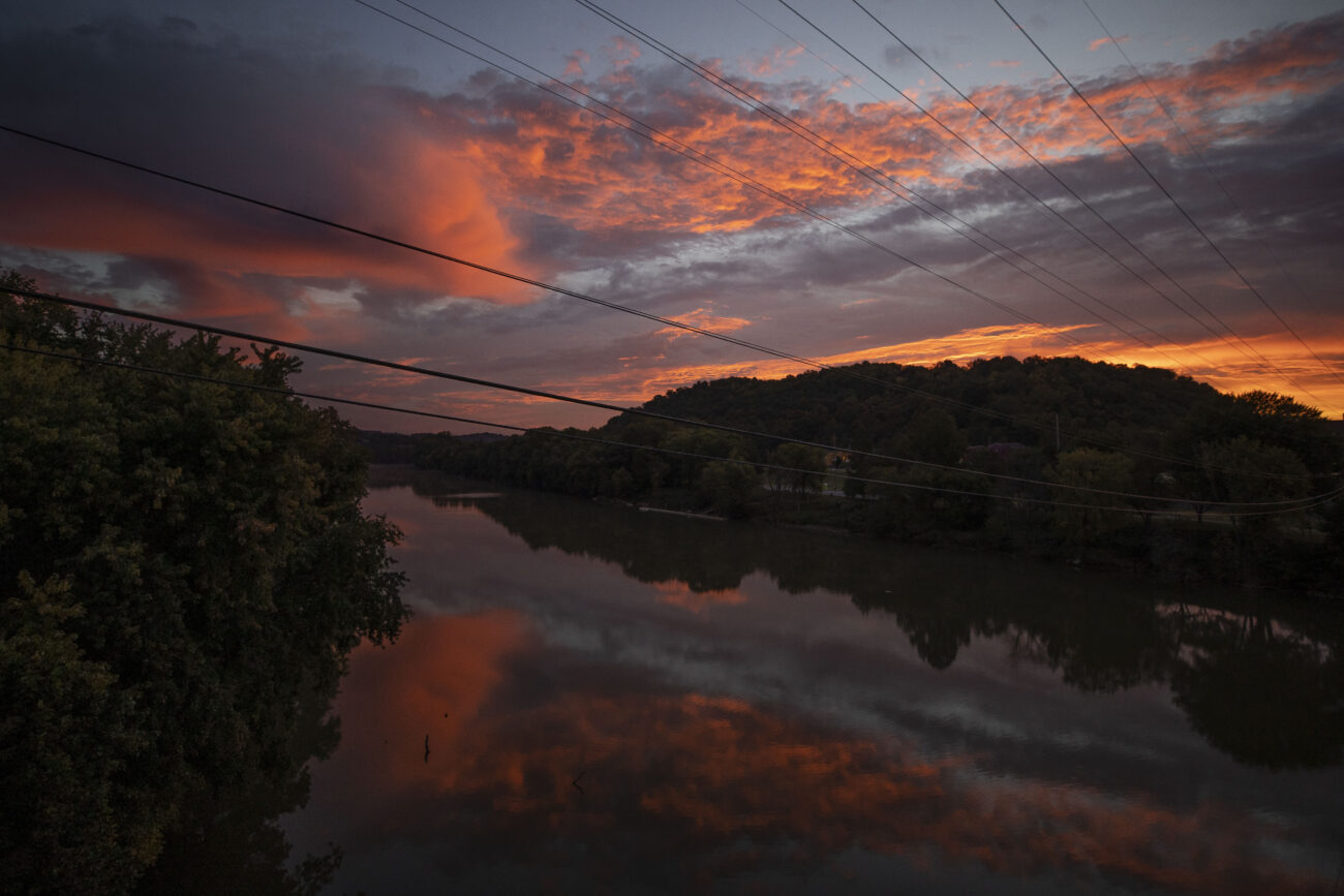 The sun peaks above the hills and Kentucky River at approximately 7:30 am in Frankfort, Kentucky on Thursday, Oct. 6, 2022. Photo by Martha McHaney.