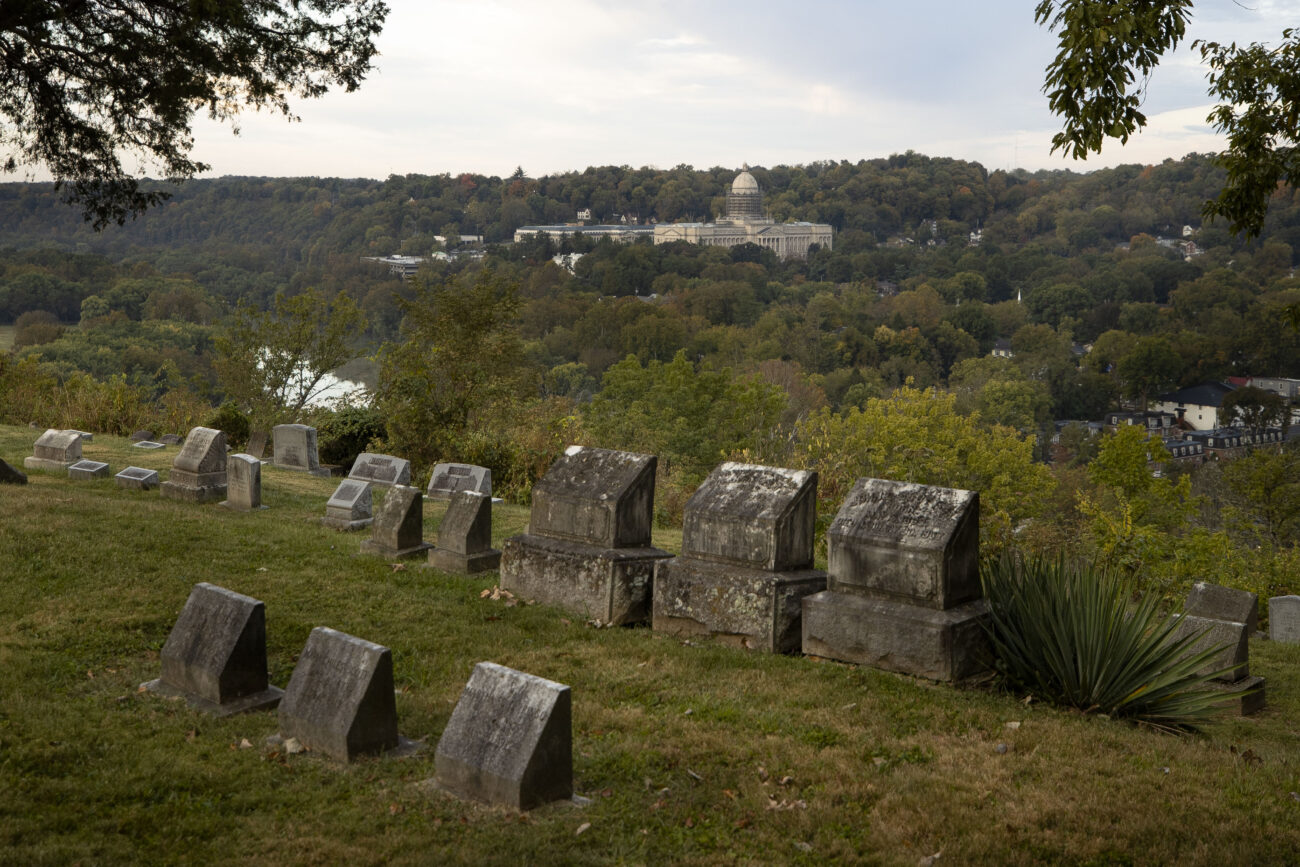 Graves at the Frankfort Cemetery loom before the Kentucky State Capitol in Frankfort, Kentucky on Thursday, Oct. 6, 2022. Photo by Martha McHaney.