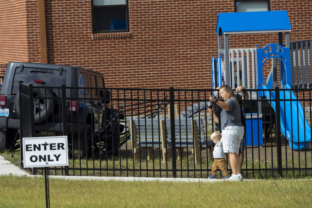 First Baptist Church secretary Cindy Couch, right, talks with officer Chad Cox about the accident at First Baptist Church in Lawrenceburg, Kentucky, on Friday, October 7, 2022. The unmanned Jeep rolled out of the parking lot of City Hall across North Main Street and into the church playground, which was recently finished. “That’s just scary, just thinking about kids being out here,” said bystander Jamie Rowland.