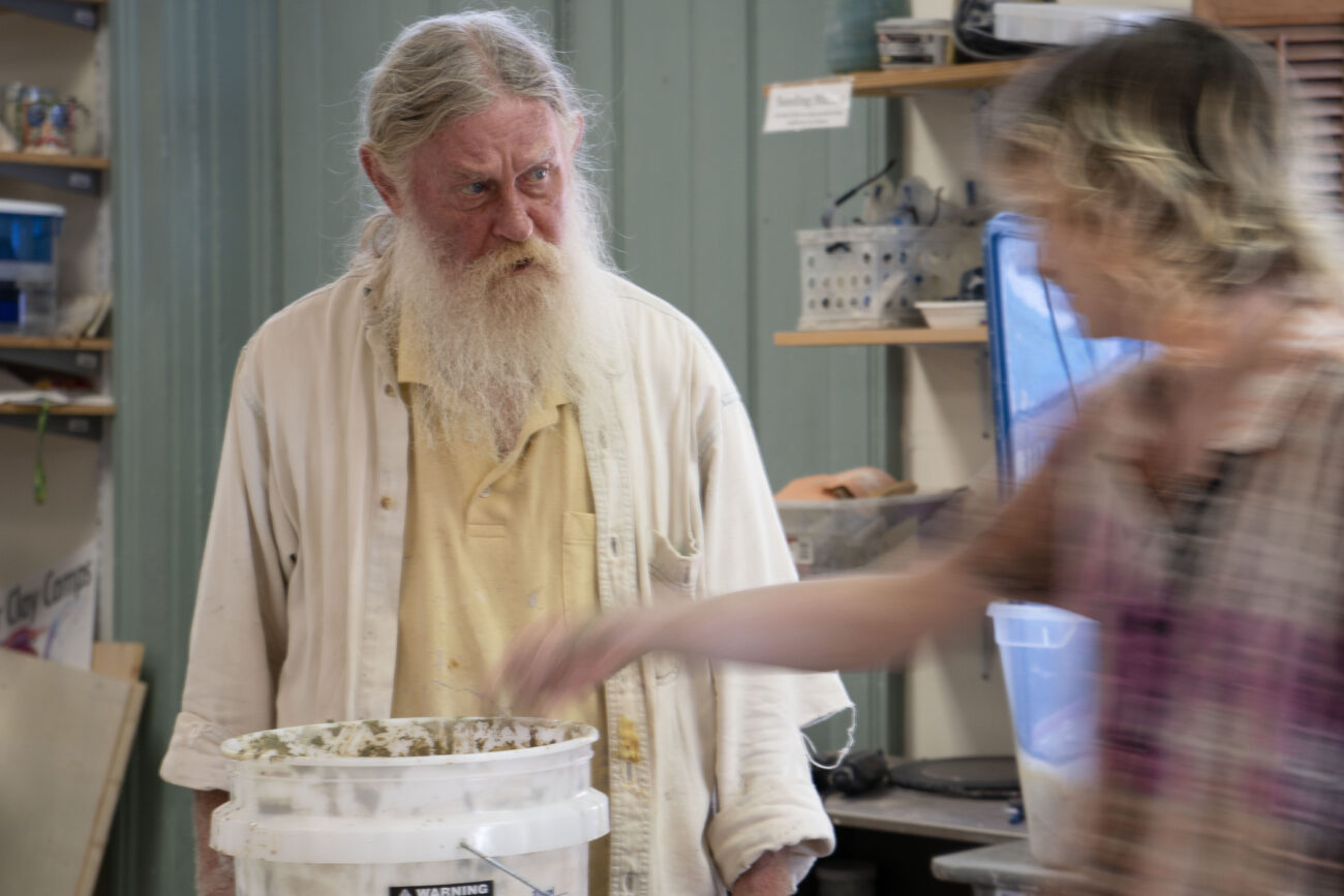 Leslie Greeman and Egan Colbert look through the clay at Broadway Clay in Frankfort, Kentucky on Friday, Oct. 7, 2022. Greeman is the calm in the shop as action happens all around him. Photo | Brooklyn Walters
