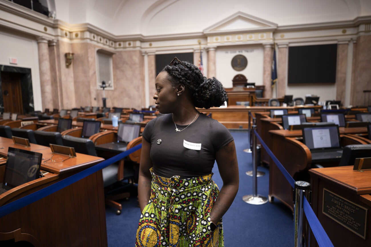 Katima Smith-Willis observes the empty Senate Chamber in the Kentucky State Capitol in Frankfort, Kentucky on Thursday, Oct. 6, 2022. Photo by Martha McHaney.