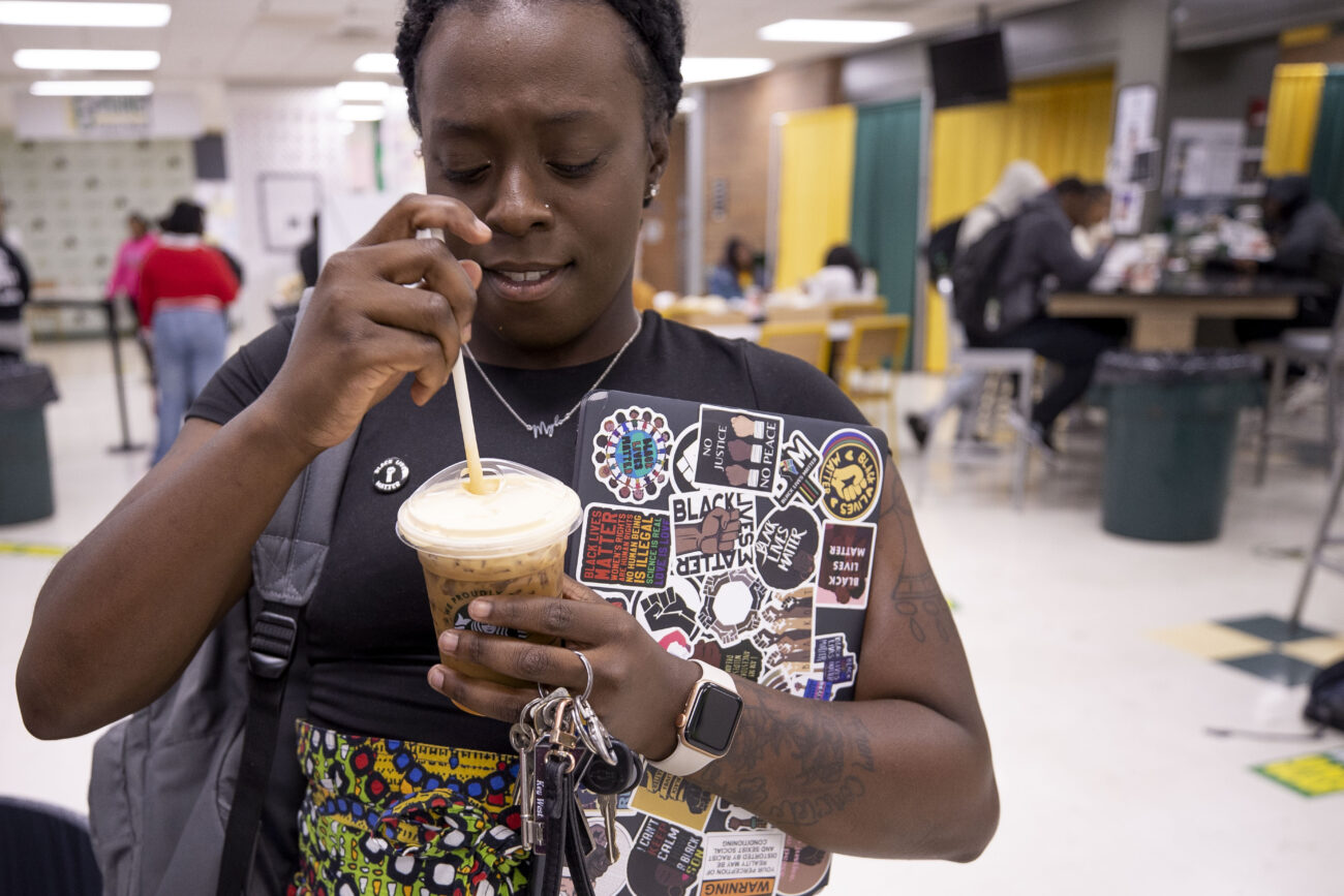 After helping register students to vote, Katima Smith-Willis grabs a coffee at the Kentucky State University Student Center in Frankfort, Kentucky on Thursday, Oct. 6, 2022. She carried her embellished laptop with her.