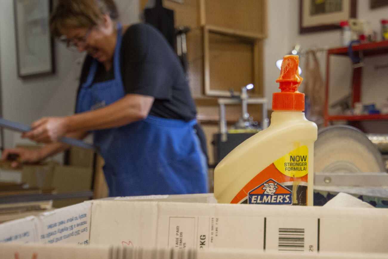 Jessie’s Art Gallery and Custom Framing owner, Lisa Dunavent, works while sharing a laugh on Thursday, October 6, 2022 in Frankfort, Kentucky. Photo | Nyah Leveretter