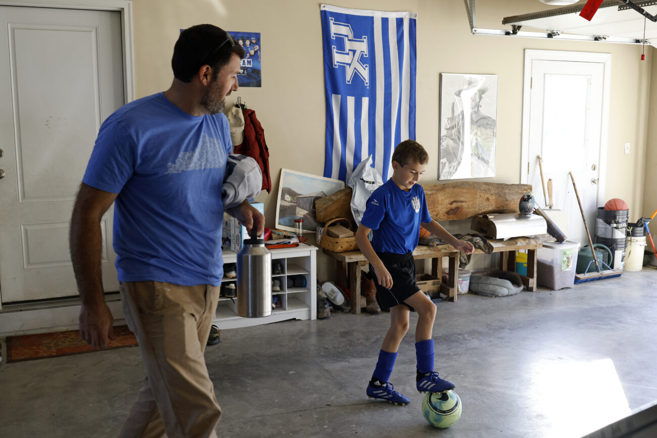 Dr. Josh Brown, left, and his son Schroder leave Brown’s home in Lawrenceburg, Kentucky, on Friday, October 7, 2022.