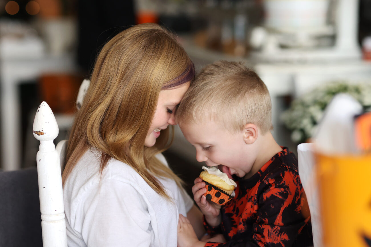 Makenna Corbin laughs at Coleston Holloway eating his cupcake in B’s Bakery in Frankfort KY, on Oct. 7, 2022.