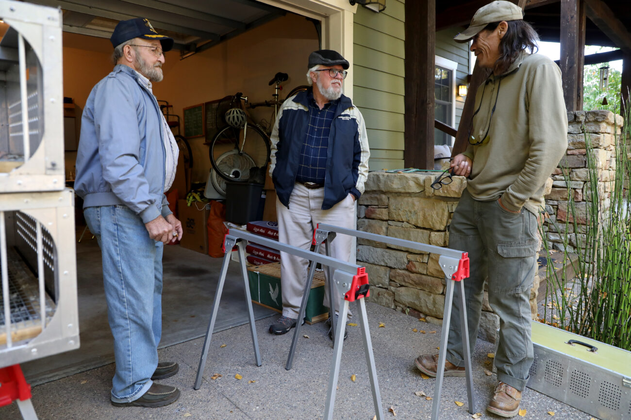 Lexington Racing Pigeon Club members Charlie Thornton (left), Tony Horn (middle), and Greg O’Conner (right) chat outside of Lexington Racing Pigeon Club President David Stephenson’s home in Lexington, Ky.